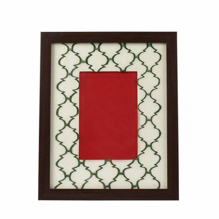 A green and white embroidered photo frame 