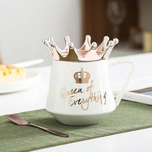 A white mug with the words &quot;Queen of Everything&quot; in golden. It has a golden crown around its rim.