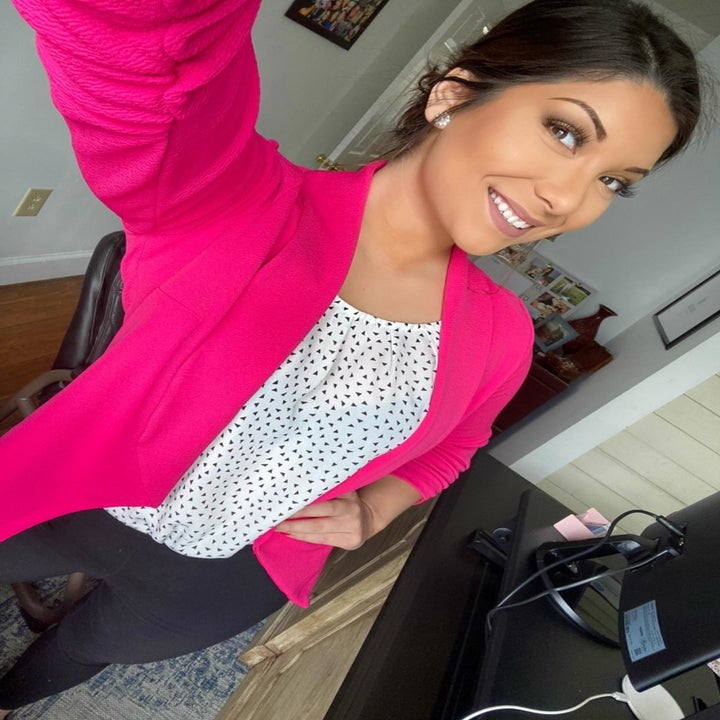 a reviewer photo of someone wearing the open front cardigan in hot pink with a polka dot top underneath and black pants