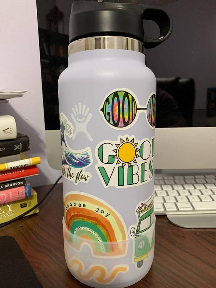 A water bottle with stickers on a desk