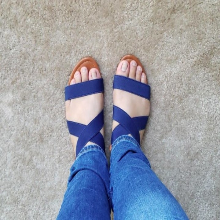 top view of a pair of navy blue strappy sandals