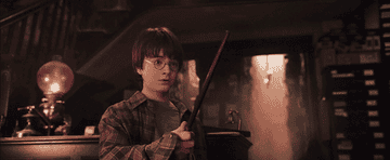 Harry holding his wand for the first time in Ollivanders 