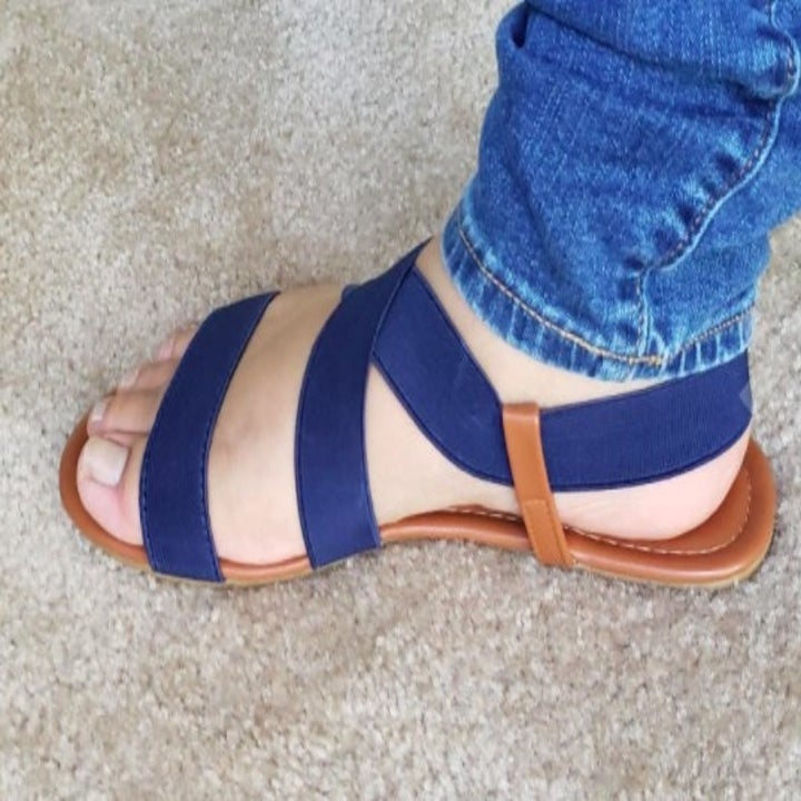 side view of a strappy navy blue sandal