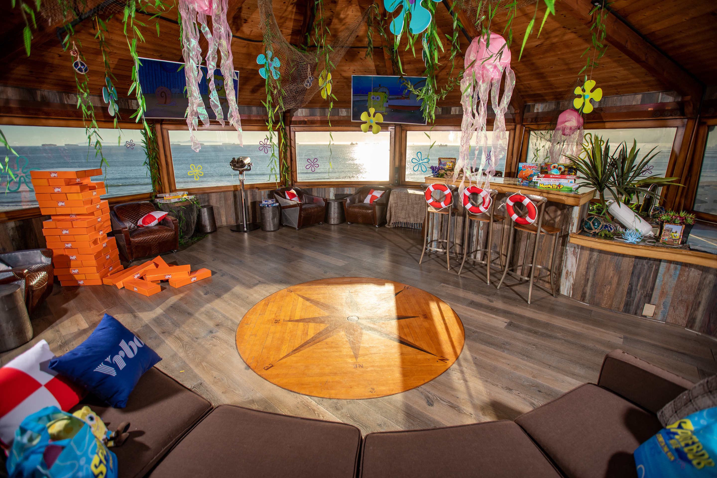 The living room which has massive windows looking out to the ocean