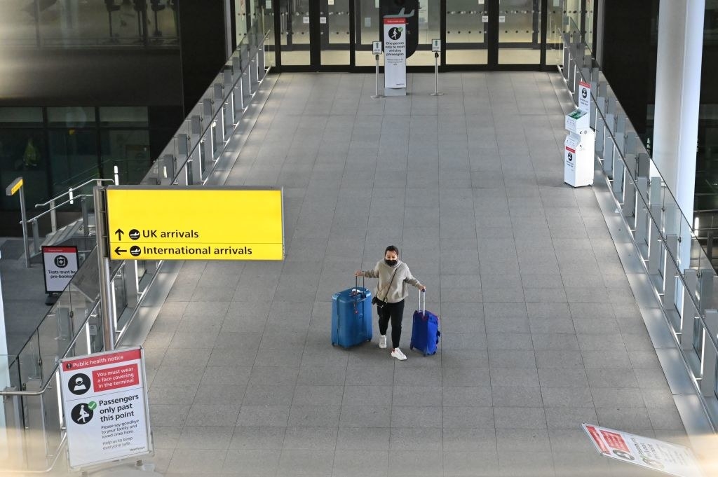 Traveler walking through empty section of London&#x27;s airport