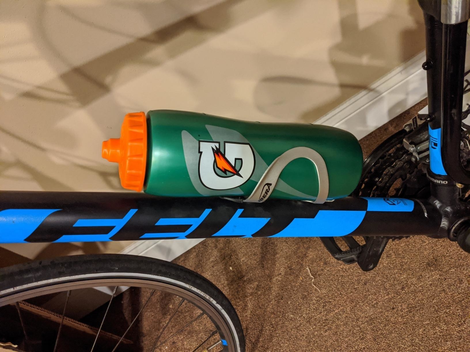 The green water bottle attached to a bike