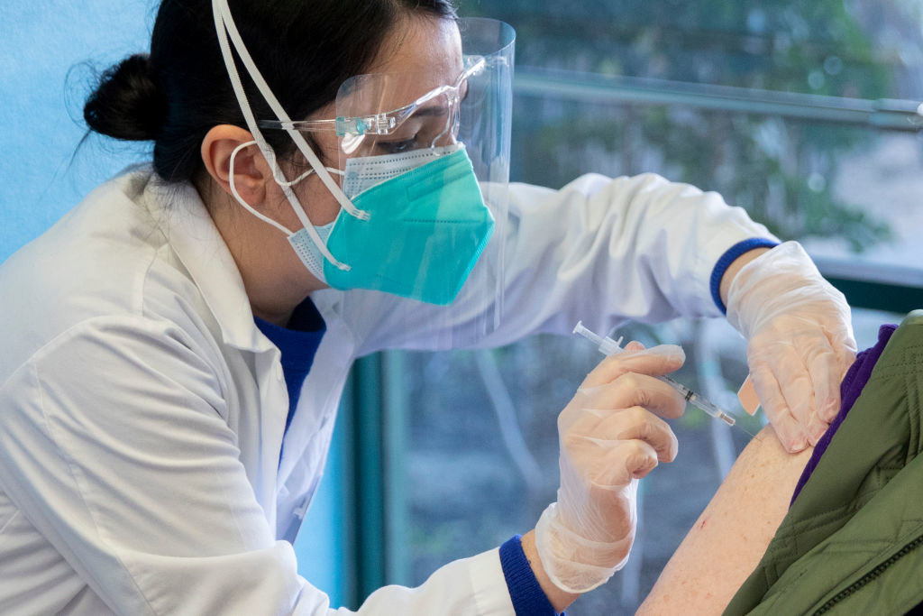 Healthcare worker giving a patient an injection