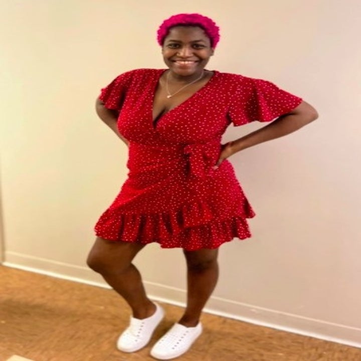 person wearing a red polka dot ruffle hem dress