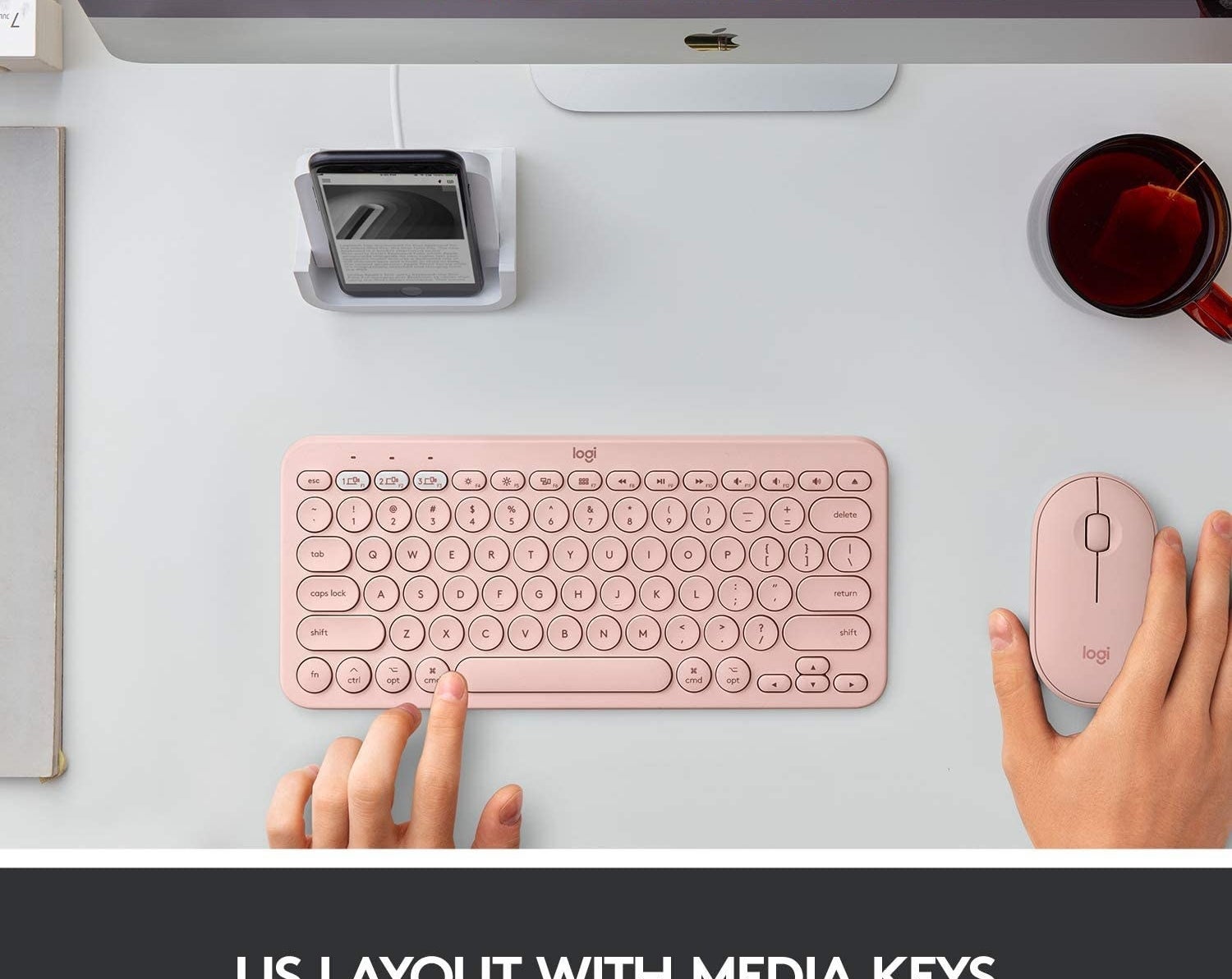 无线键盘在电脑前亮粉红色”class=