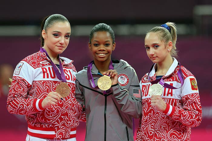 Bronze medalist Aliya Mustafina of Russia, gold medalist Gabrielle Douglas of the United States and silver medalist Victoria Komova of Russia pose after the medal ceremony at the 2012 Olympics