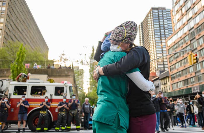 Medical workers hug outside NYU Langone Health hospital in New York City (May 2020)