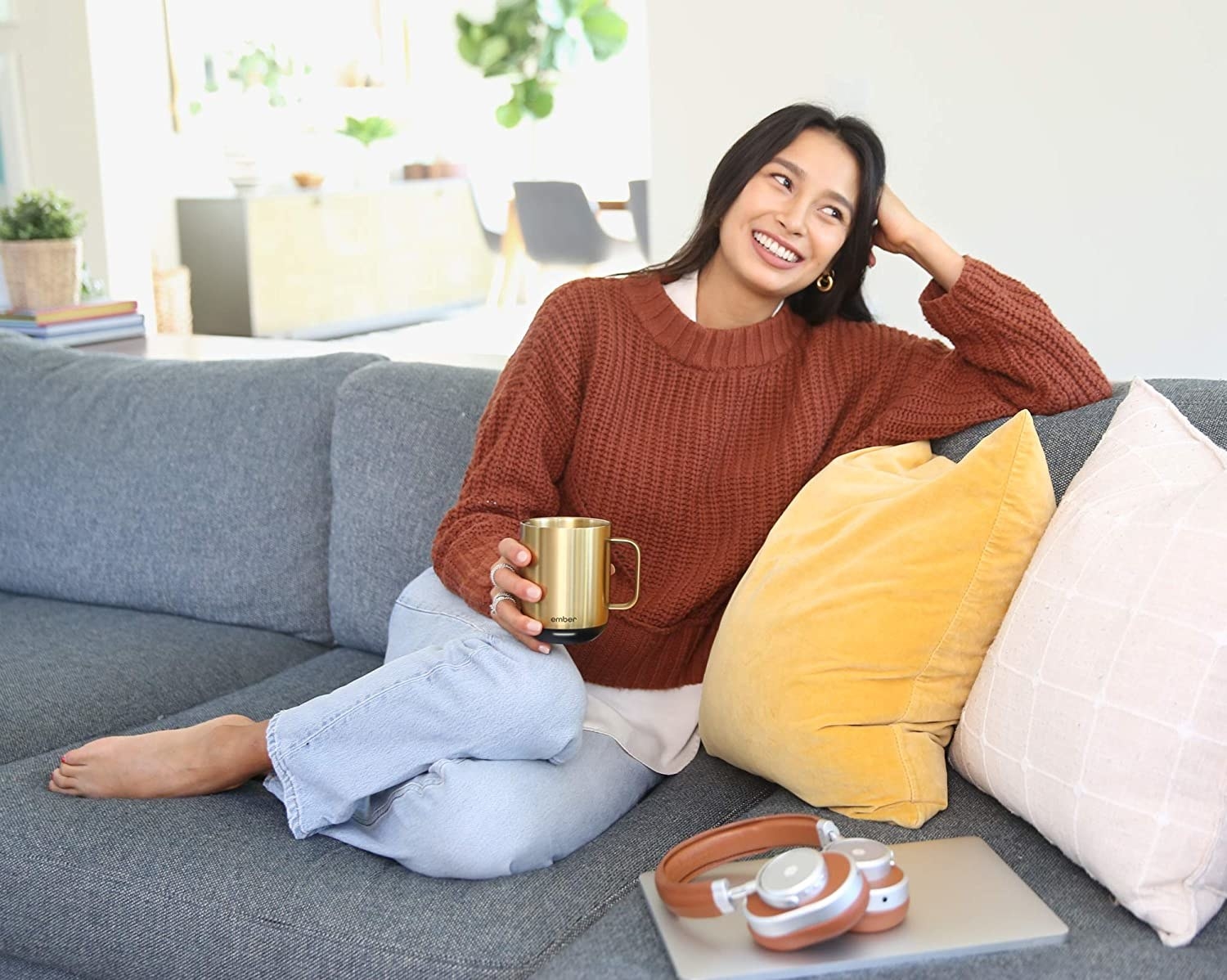 Model holding the gold mug