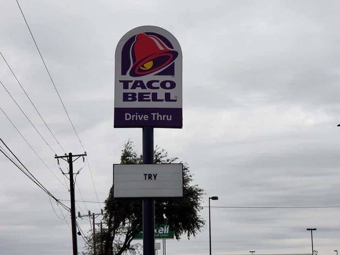 sign reading try below a Taco Bell logo