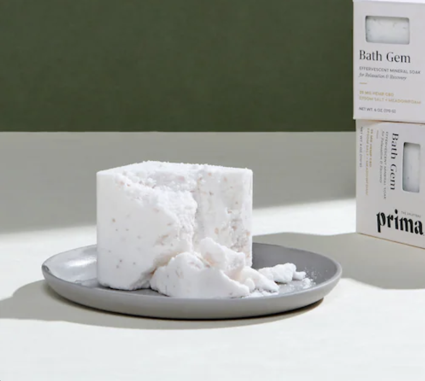 A white square-shaped bath soak slightly crumbled to show texture