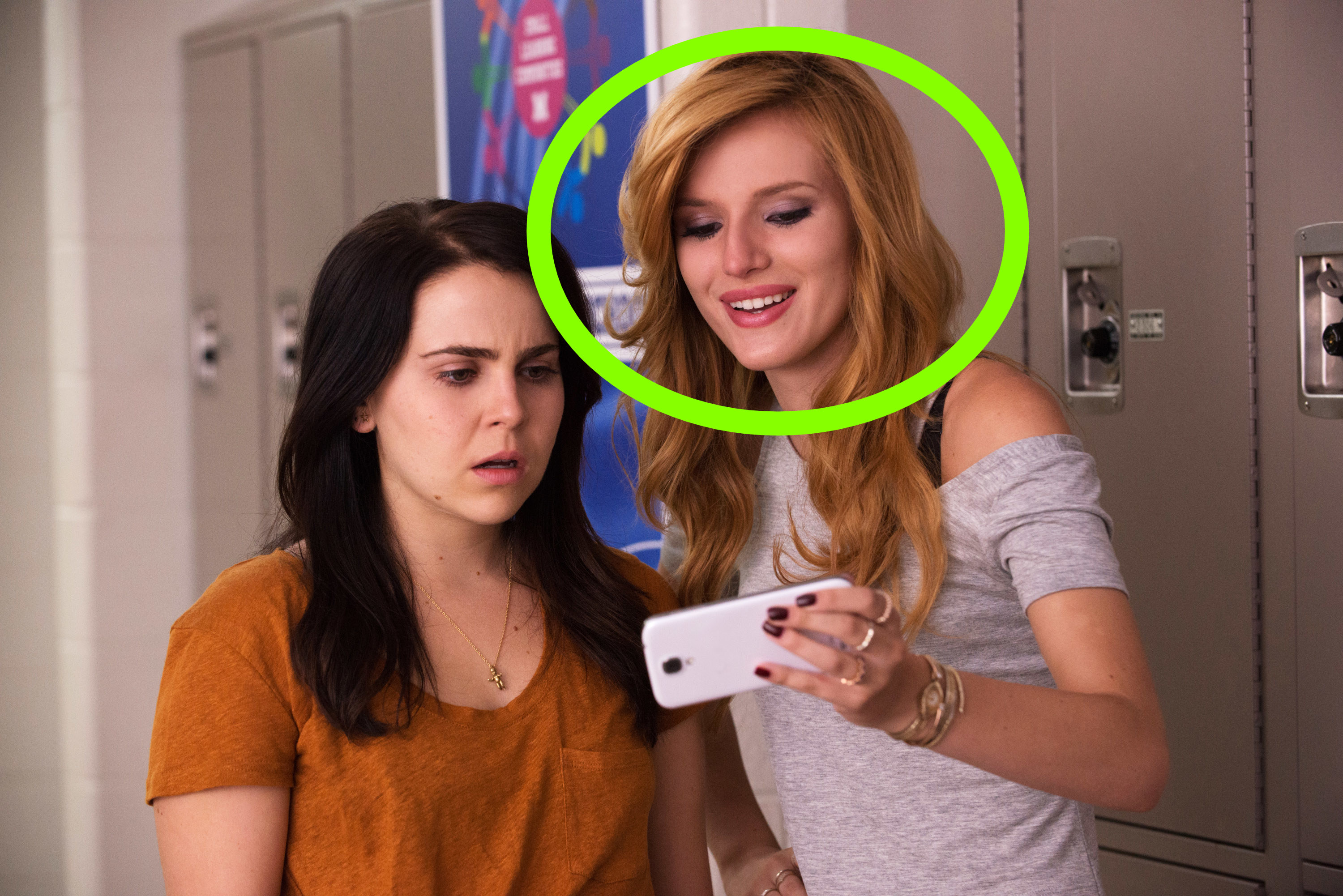 Bella showing Mae her phone in the school hallway in the film