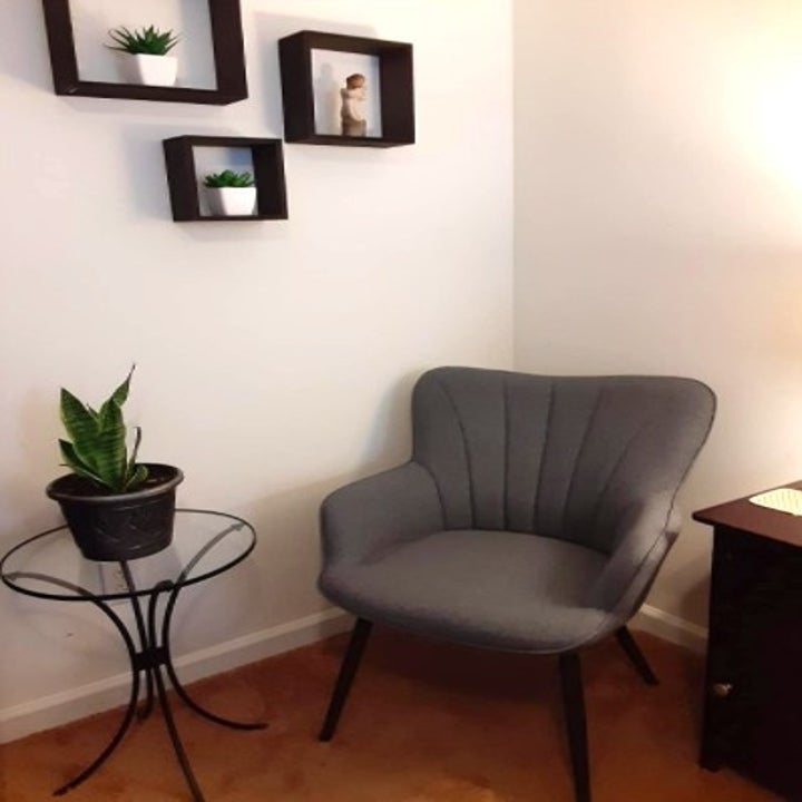 gray accent chair placed in the corner of a room