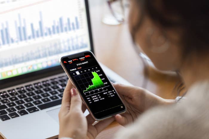 Person investing on phone