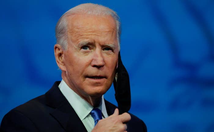 President Joe Biden taking off his face mask before giving a speech