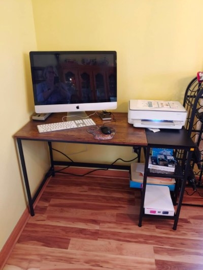 wooden desk with storage with a computer and printer on it