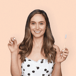 A gif of a model putting a white tab in their mouth and starting to brush their teeth