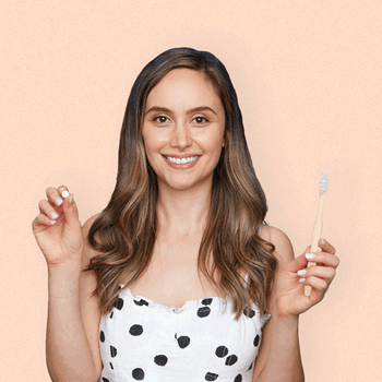 A gif of a model putting a white tab in their mouth and starting to brush their teeth
