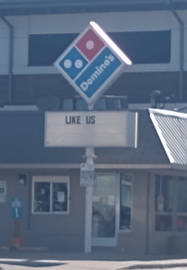 sign reading like us below a Domino&#x27;s logo