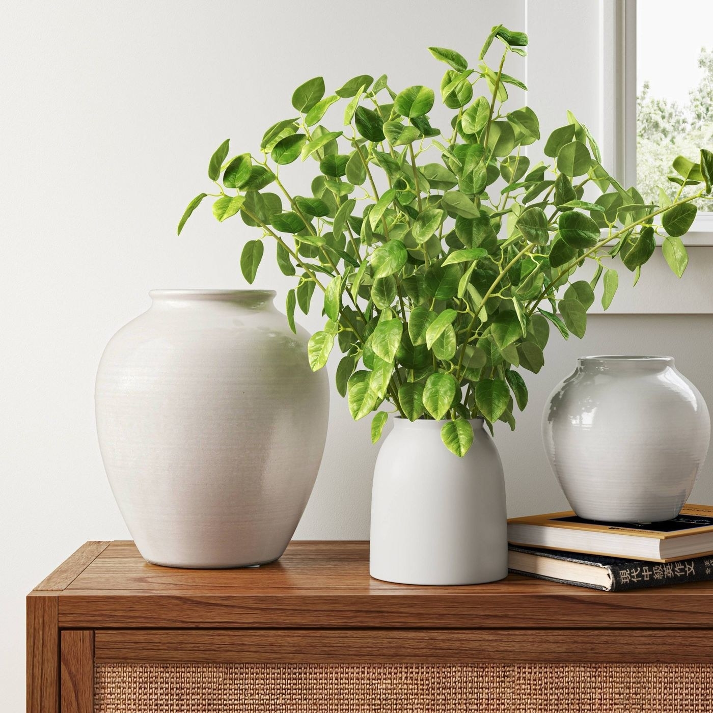 Leafy faux plant in white vase