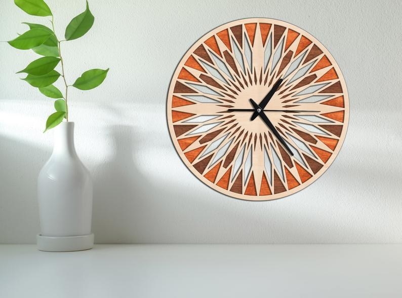 a numberless and bright circular clock made up of geometric shapes 