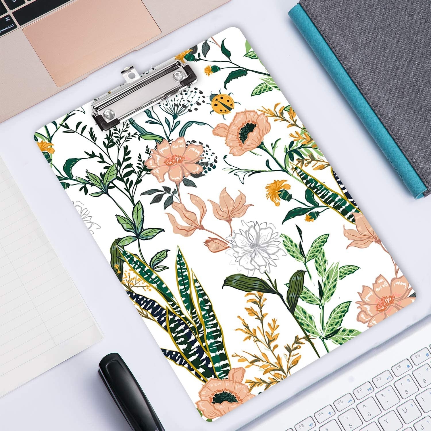 A floral clipboard on a desk 