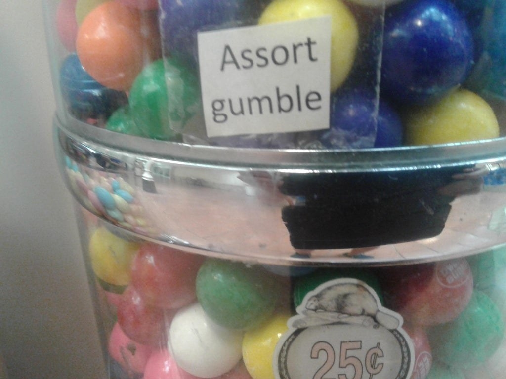 Sign reading &quot;assort gumble&quot; on a gumball container