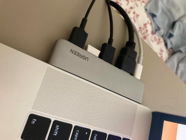 laptop adapter on the side of computer with multiple cords plugged into it