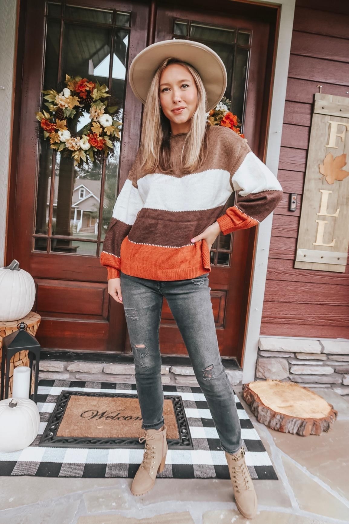 The pullover sweater worn by an Amazon reviewer and paired with jeans