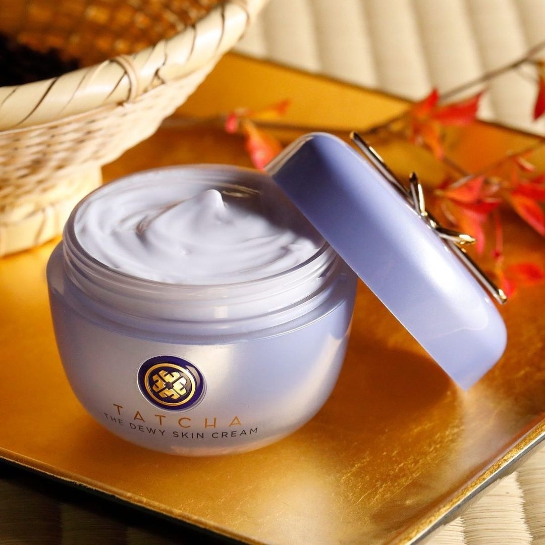 An open container of face cream on a table