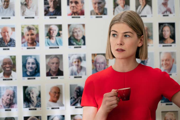 Rosamund Pike holds a tiny coffee cup in I Care A Lot