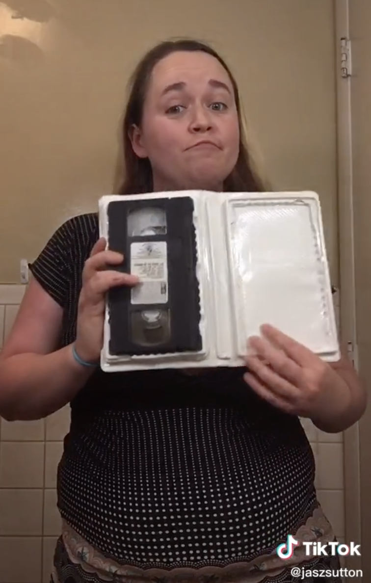Person holding up a VCR