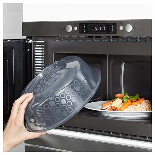 A microwave splatter cover being inserted into a microwave 