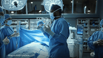 Doctors fistbumping before surgery