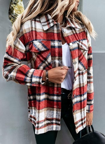 model wearing a red, black, and white flannel with a t-shirt underneath