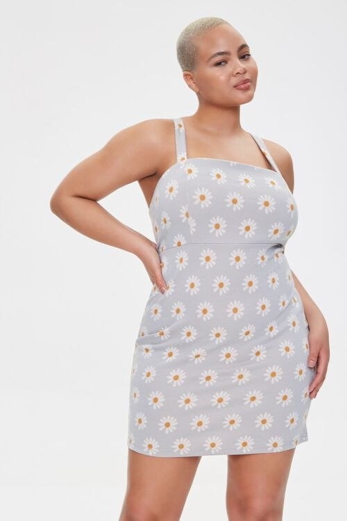 model wears sleeveless square neck gray mini dress with daisy print