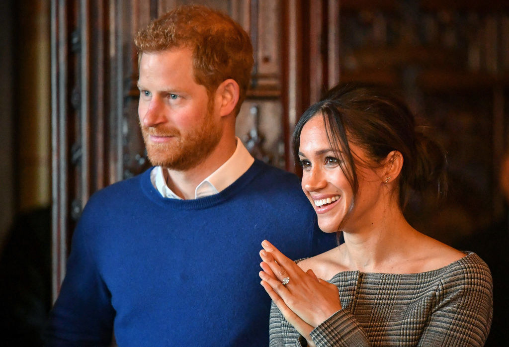 Prince Harry (L) and Meghan Markle watch a performance by a Welsh choir in the banqueting hall during a visit to Cardiff Castle Cardiff, Wales