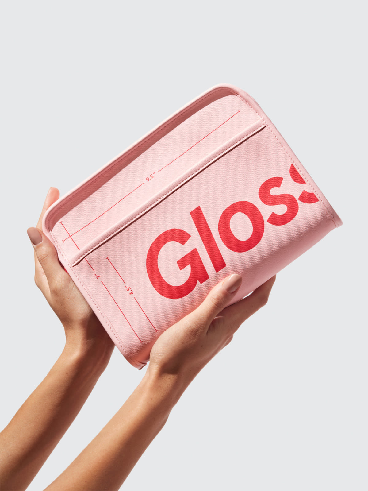 The zippered pink and red pouch with glossier logo