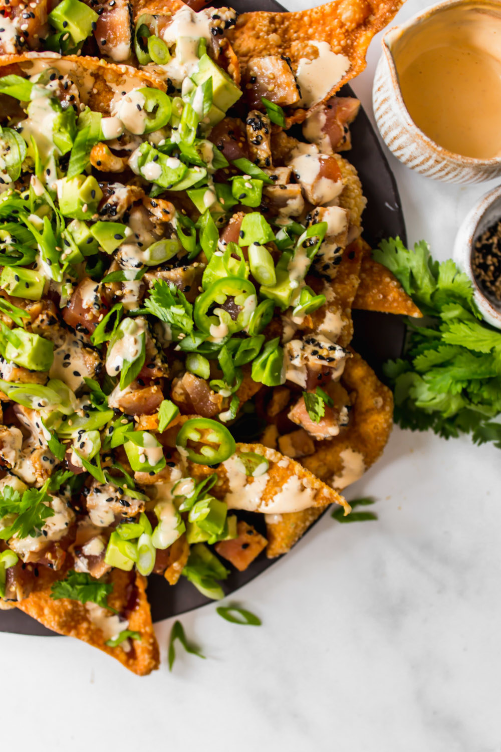 Wonton nachos with ahi tuna poke and greens.