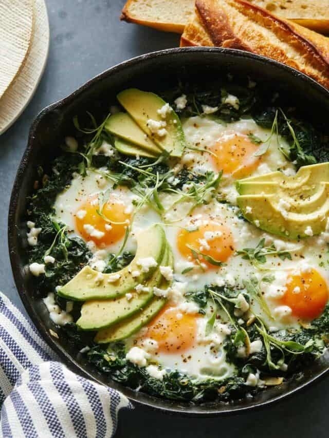 Green shakshuka with baked eggs, avocado, and feta. 