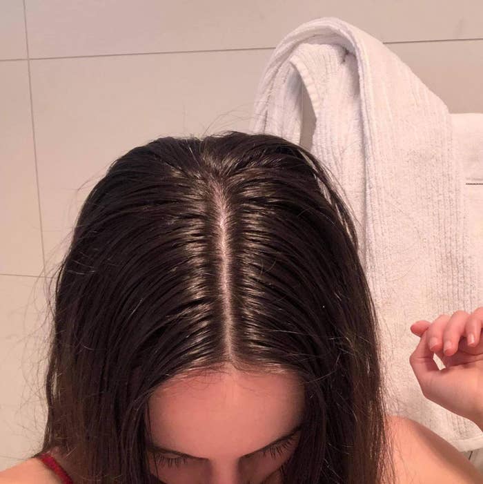 A user showing off greasy roots in their hair