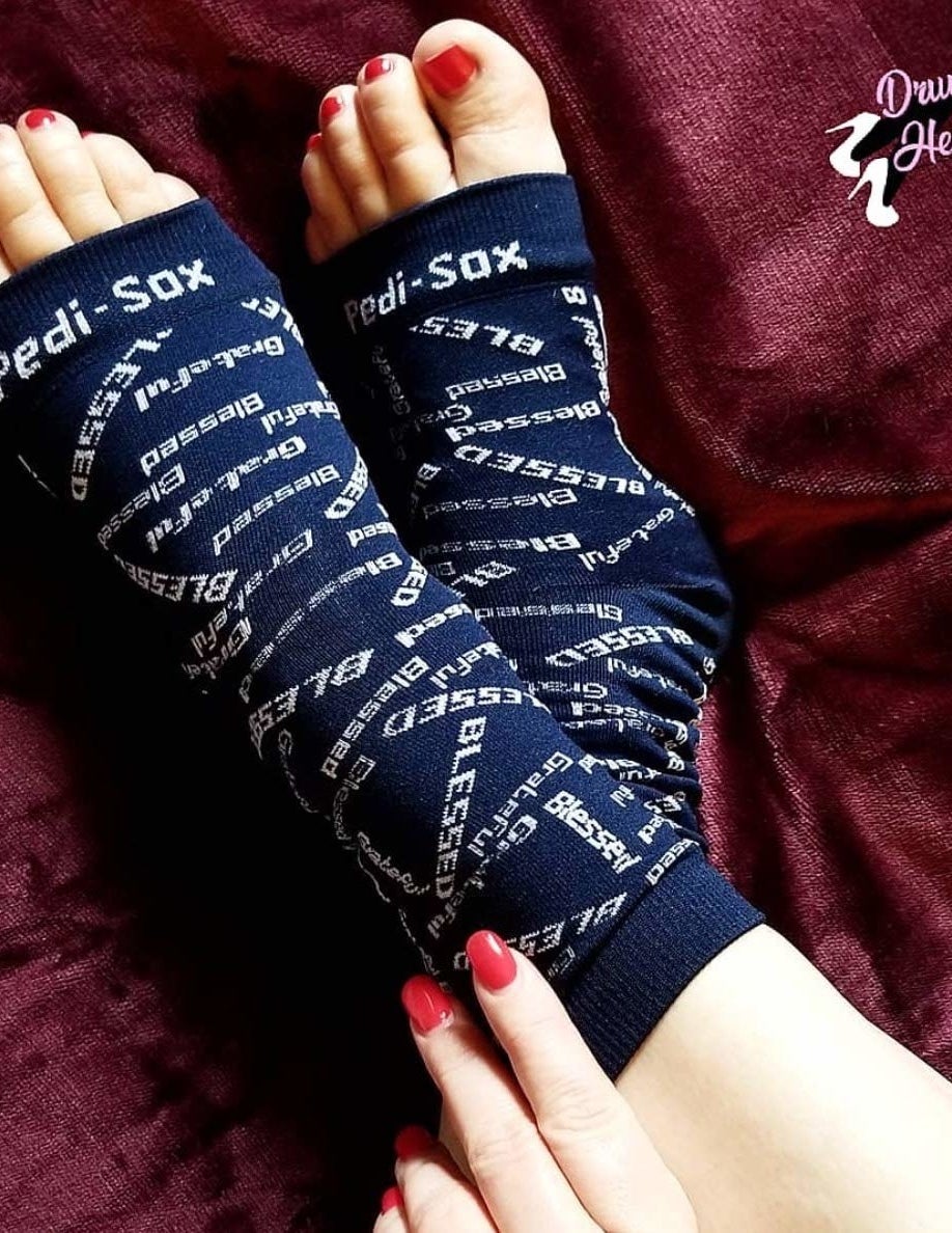 a model wearing the black socks which say &quot;blessed&quot;