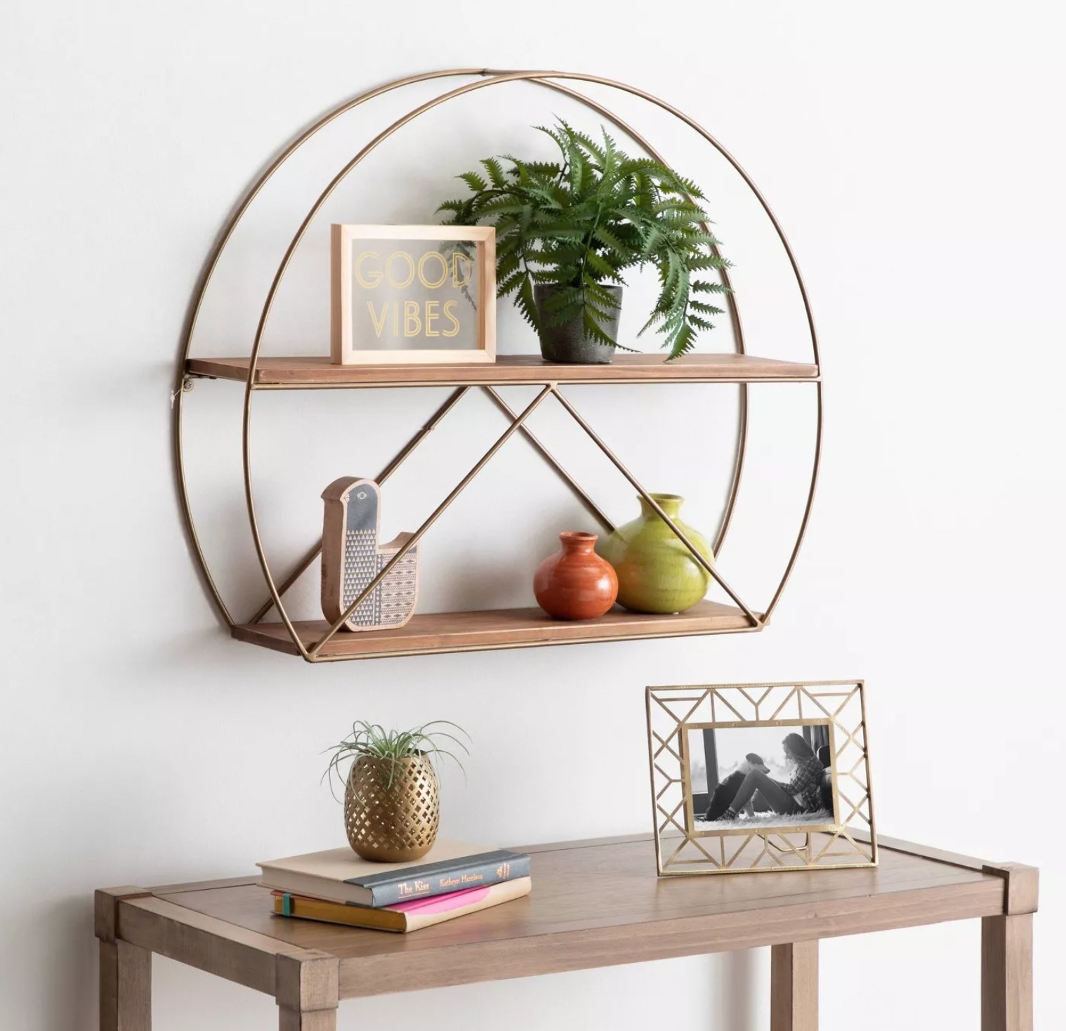 The rounded wall shelf with pots and decorations on it