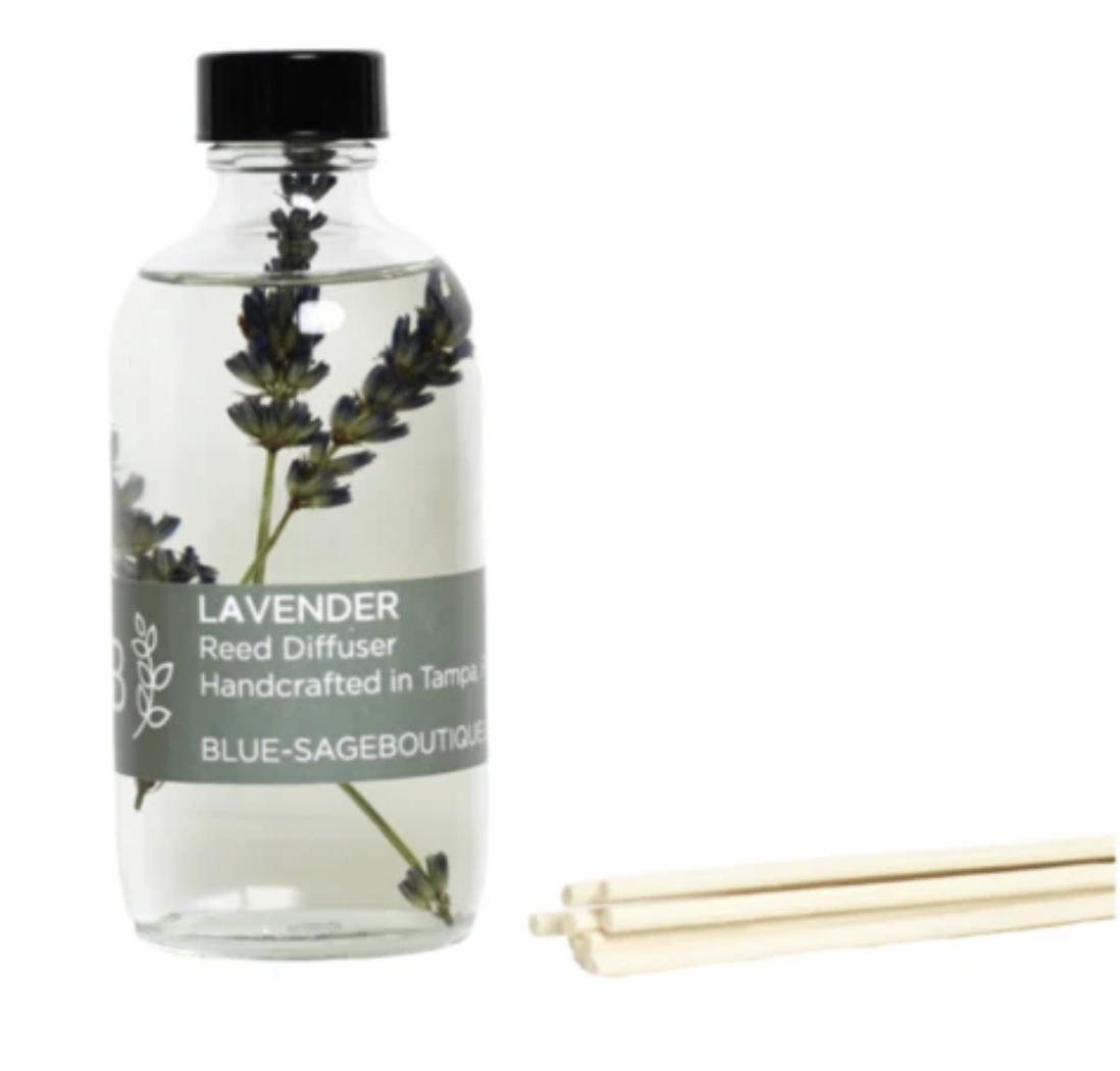 A clear glass diffuser with lavender and diffuser sticks 