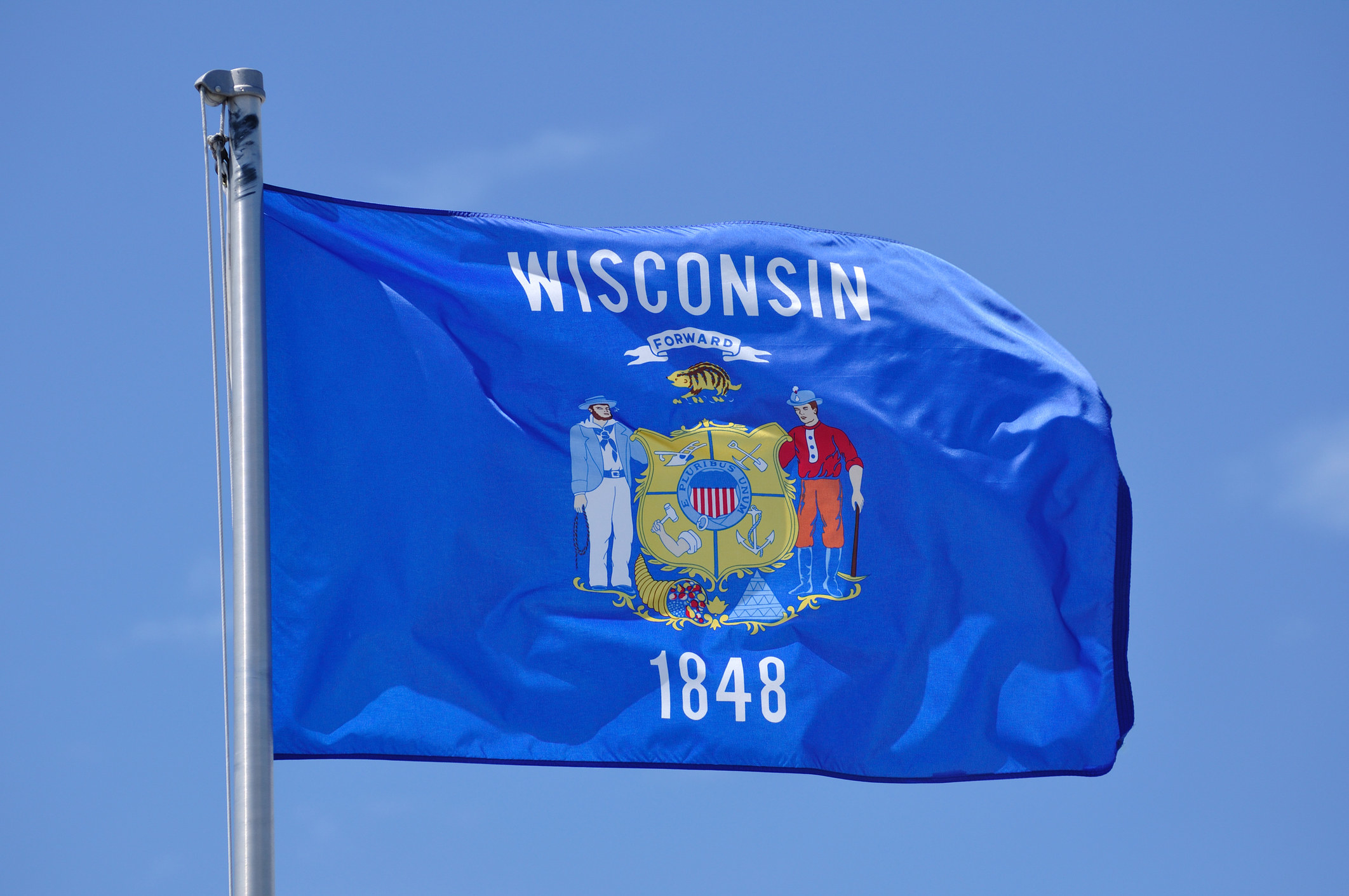  the Wisconsin state flag waving in the sky