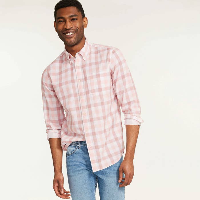 A person wearing a button up shirt with jeans