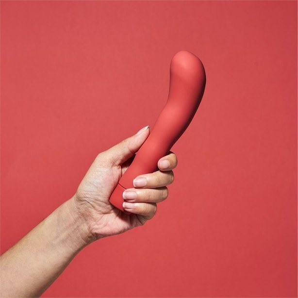 A person holding the rigged, curved wand 